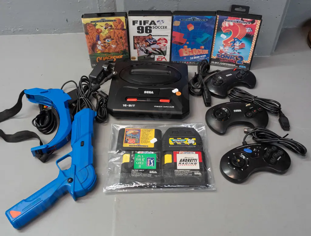 Sega Megadrive (Genesis) game console with 3 controllers with 8 games, 4 with original boxes, and a Sega branded laser Image 1++