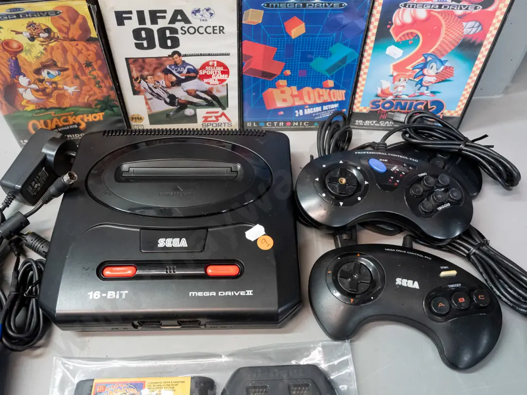 Sega Megadrive (Genesis) game console with 3 controllers with 8 games, 4 with original boxes, and a Sega branded laser Image 1++