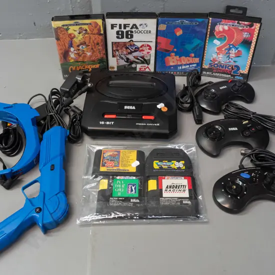 Sega Megadrive (Genesis) game console with 3 controllers with 8 games, 4 with original boxes, and a Sega branded laser