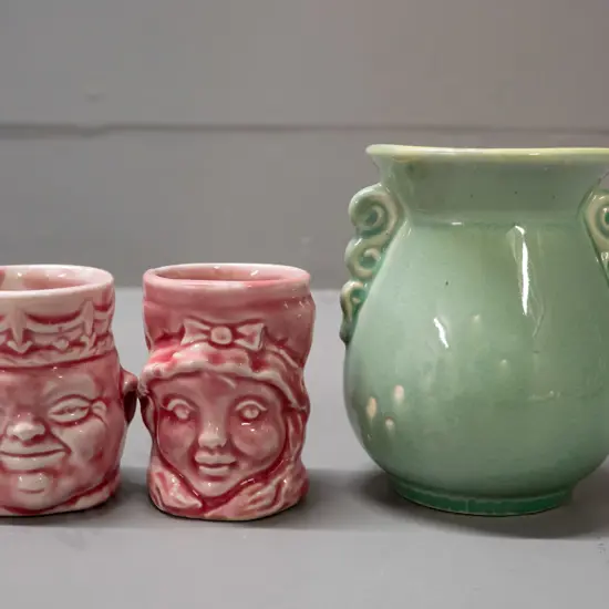 small (Crown Lynn?) vase marked .130. with a small glaze fault H-95 W-85 and 2 pink figural egg cups, one