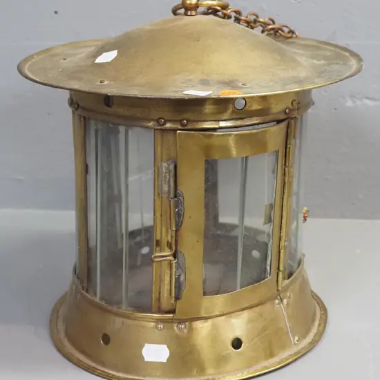 brass and brass plated metal hanging candle lantern with slatted glass panels, one loose one inside, has some dents and