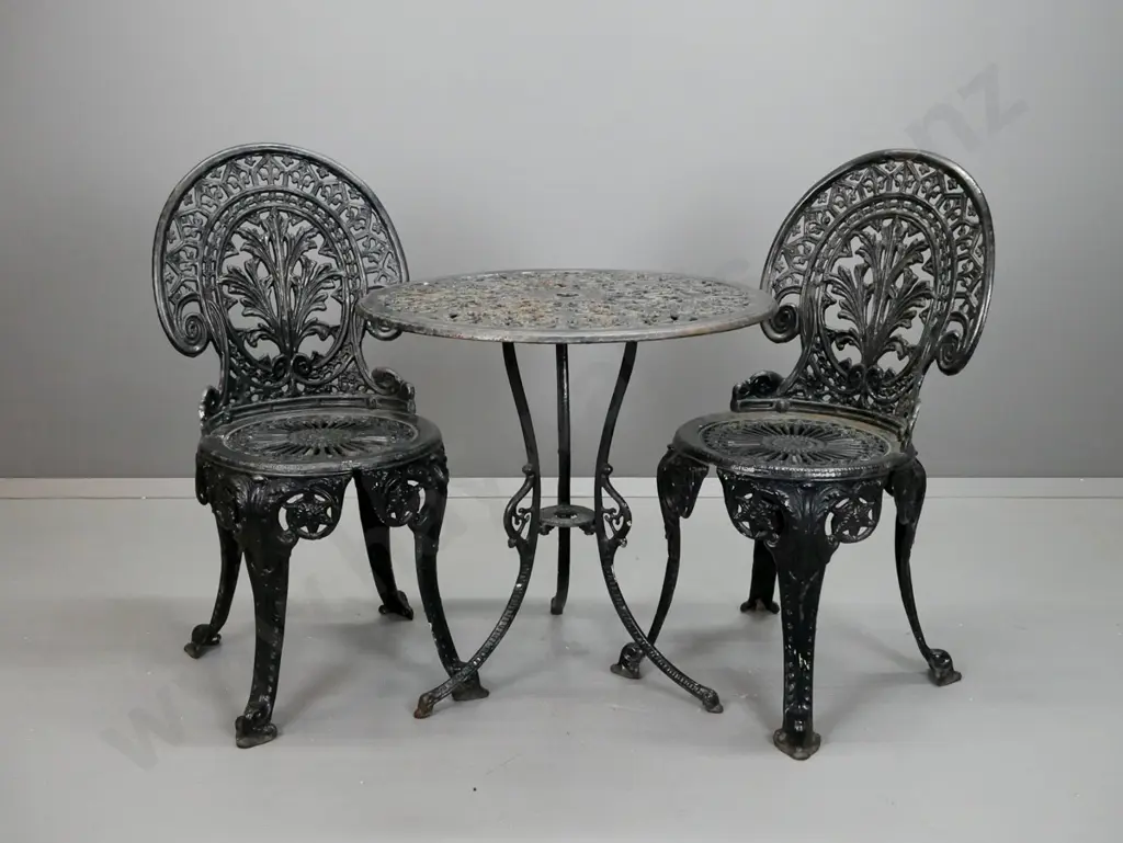 heavy cast metal black painted round outdoor 3-legged table with umbrella hole and 2 chairs - damage on edge of table, Image 1++