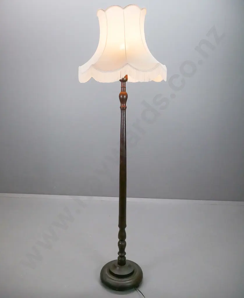 vintage oak standard lamp with turned column, stepped circular base on turned feet, fringed waisted shade. Some staining Image 1++