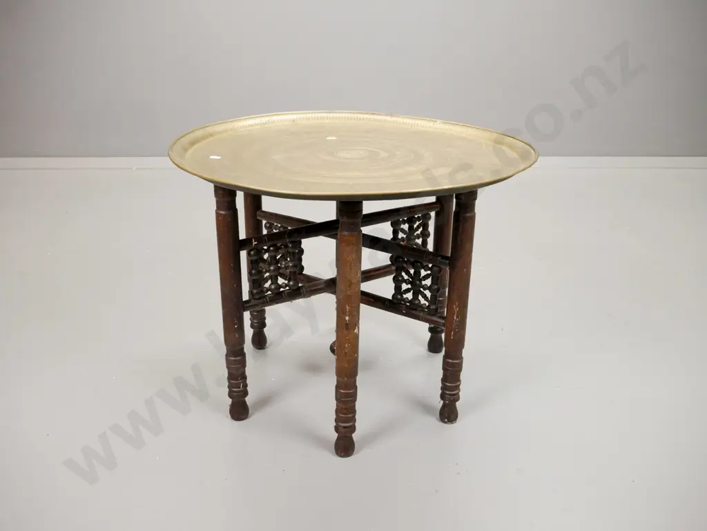 Egyptian? embossed brass tray table on folding beech base with turned bracket decoration. Minor paint flecks H-450 D-580 Image 1++