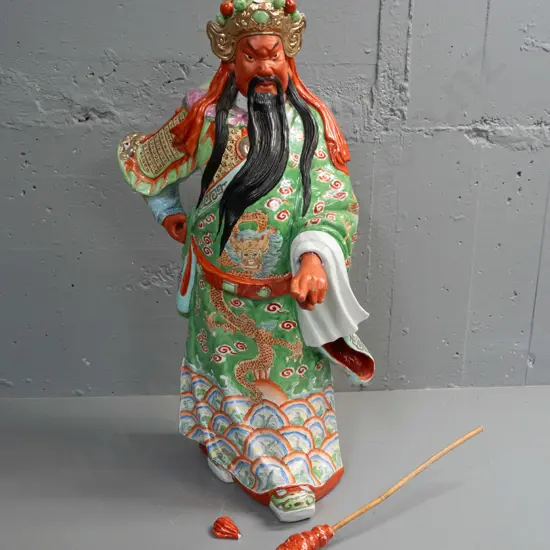 large Chinese heavy porcelain warrior figure with loose timber handled ceremonial staff - one hand loose, some chips and