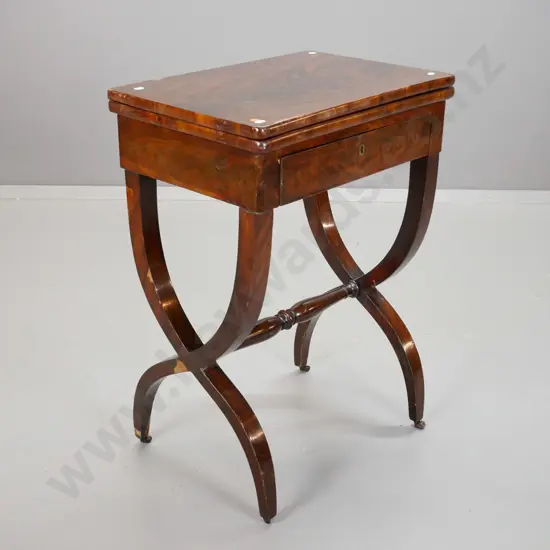 Regency flame mahogany swivel top games/work table, top with oval baize panel & tooled leather edge, frieze drawer,