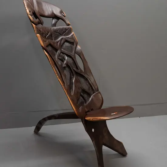 2-piece collapsible carved and pierced African hardwood chair with elephant, antelope, etc. - small crack in seat H-770