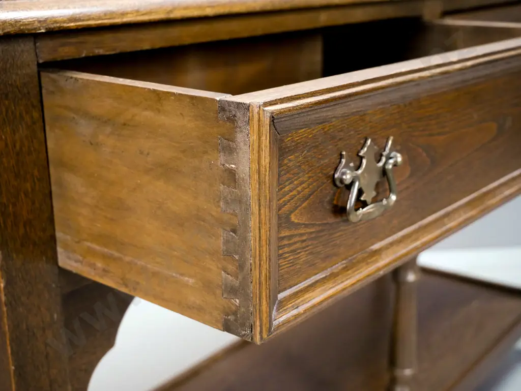 country oak style 2-drawer dresser base with shaped cutout corners, turned legs, bottom shelf, brass handles - some wear Image 1++