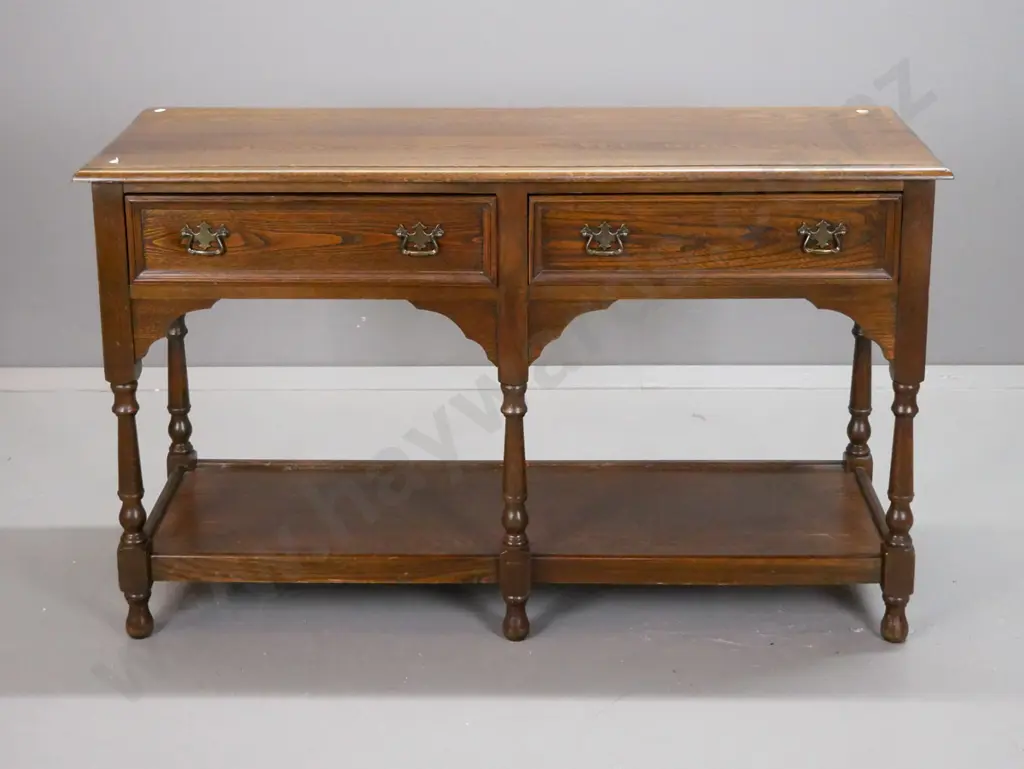 country oak style 2-drawer dresser base with shaped cutout corners, turned legs, bottom shelf, brass handles - some wear Image 1++