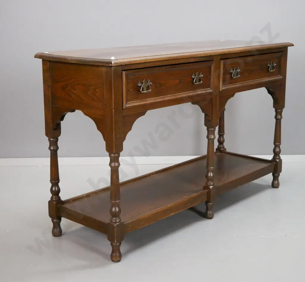 country oak style 2-drawer dresser base with shaped cutout corners, turned legs, bottom shelf, brass handles - some wear Image 1++