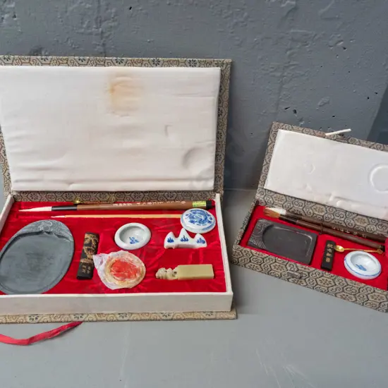 2 Chinese painting / desk sets in fabric covered cases, w/ various porcelain containers, brushes, pallette, soapstone