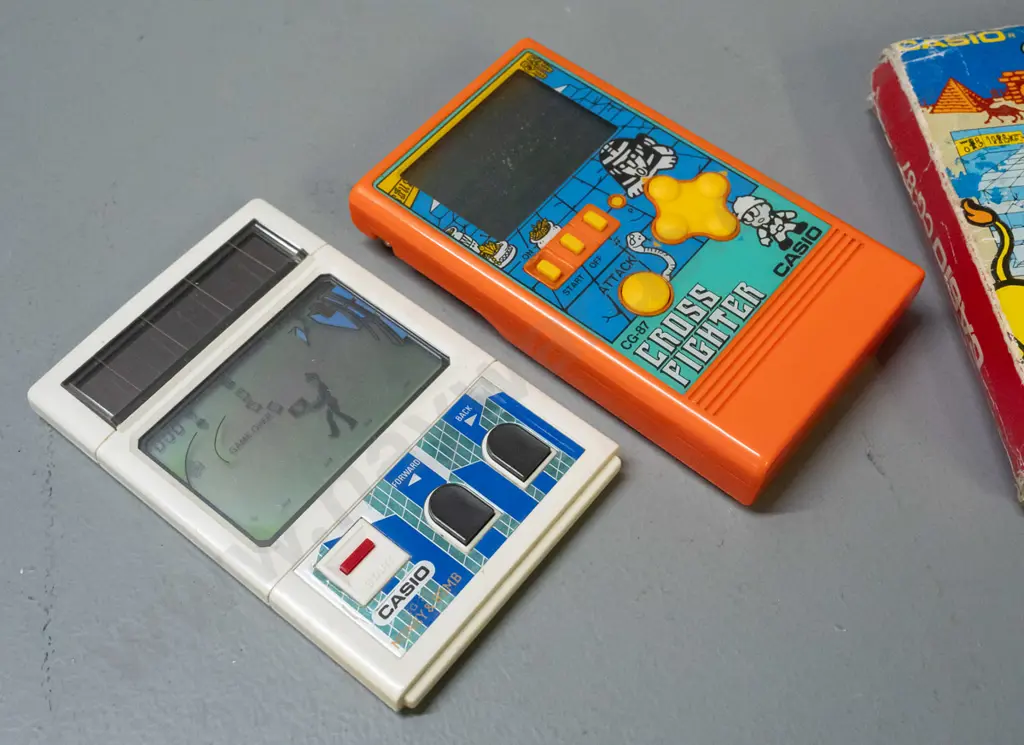2 1980s Casio miniature game consoles - Cross Fighter with original box and "Money & Bomb" - box is very worn - untested Image 1++