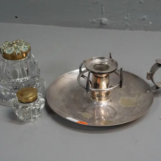 plated chamber stick and 2 cut glass inkwells with hinged brass lids. Chamber stick has some wear to plating, one bent
