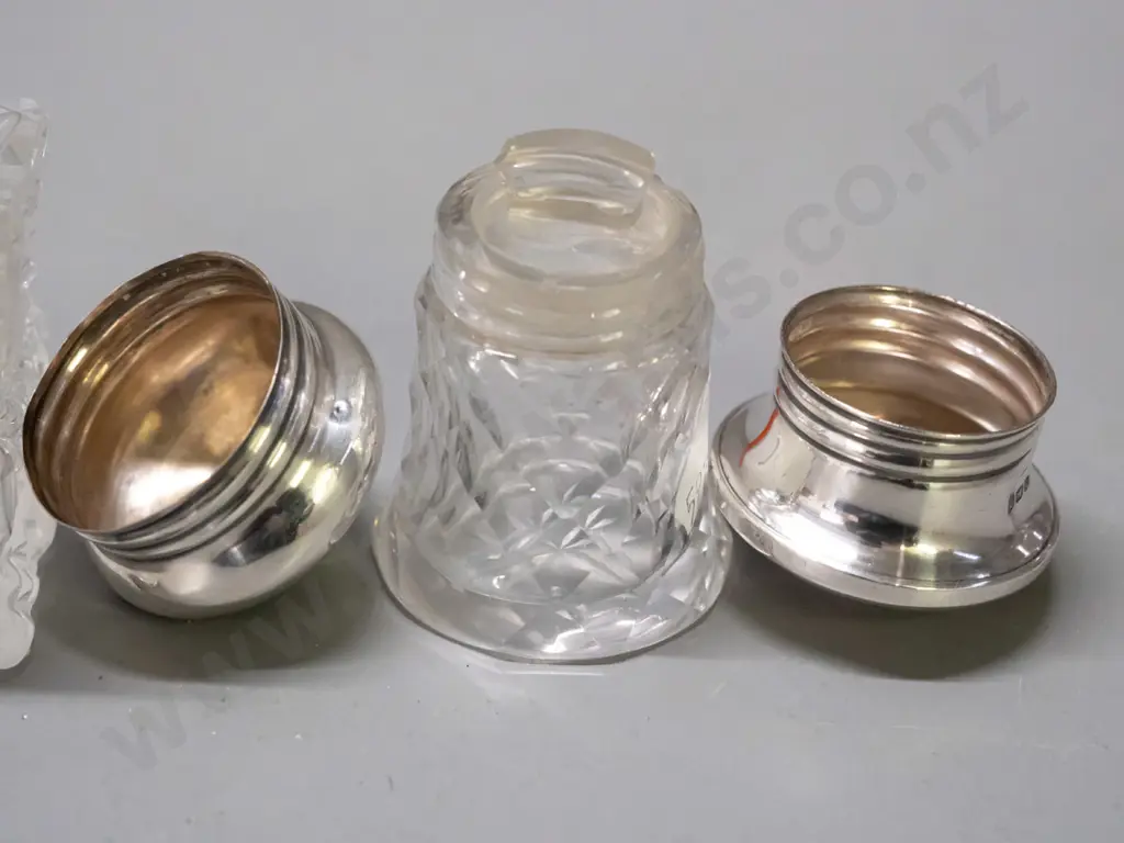 2 cut glass scent bottles with sterling silver tops - smaller one has glass stopper under cap, both caps have some dents Image 1++