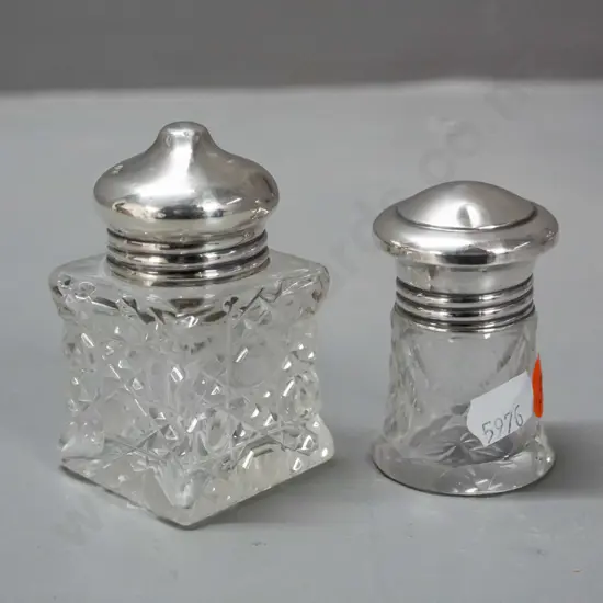 2 cut glass scent bottles with sterling silver tops - smaller one has glass stopper under cap, both caps have some dents