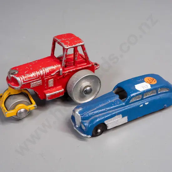 2 small cast metal toy vehicles - road roller marked 413 and symbol that looks like "AB" and a vintage car with black