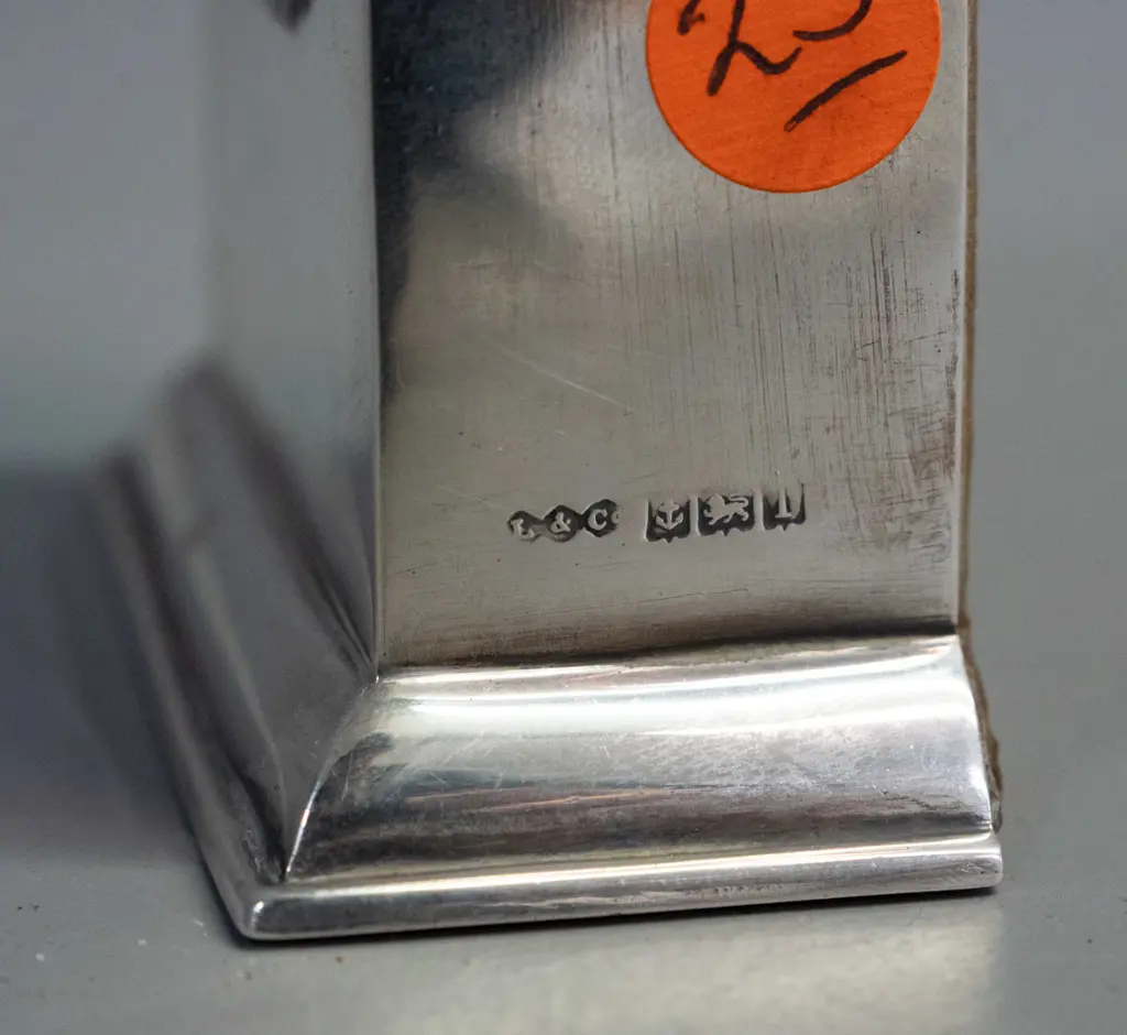 small mantel clock in sterling silver case, enamel band around bezel, brass bezel and porcelain face marked Swiss made Image 1++