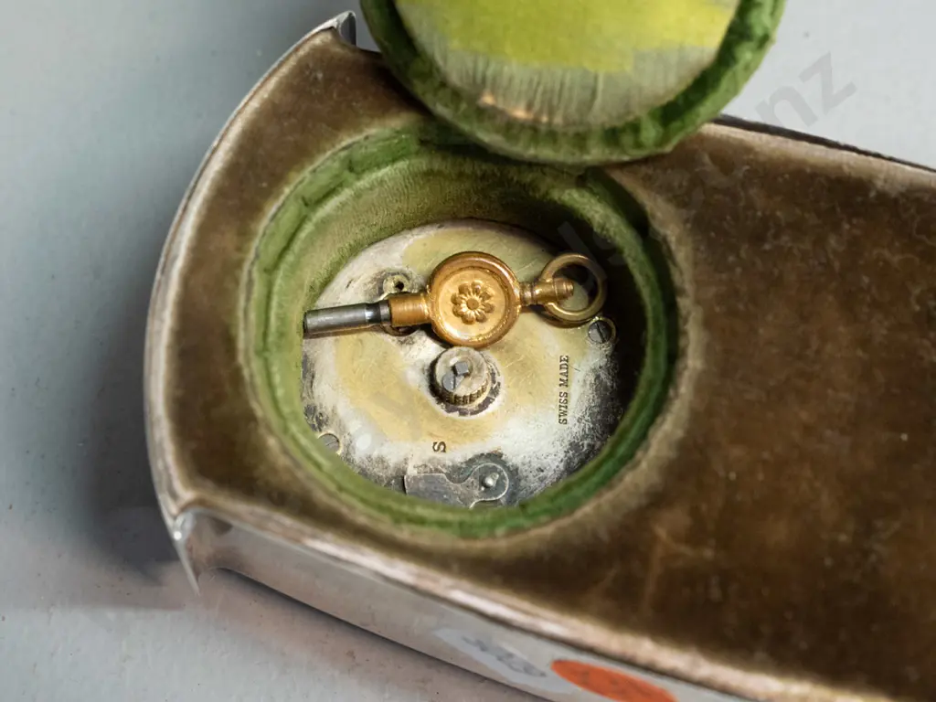 small mantel clock in sterling silver case, enamel band around bezel, brass bezel and porcelain face marked Swiss made Image 1++