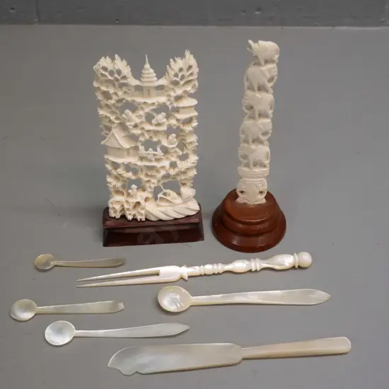 2 asian faux-ivory carved composite ornaments on wooden bases & 6 small mother of pearl condiment items. Tallest is H130