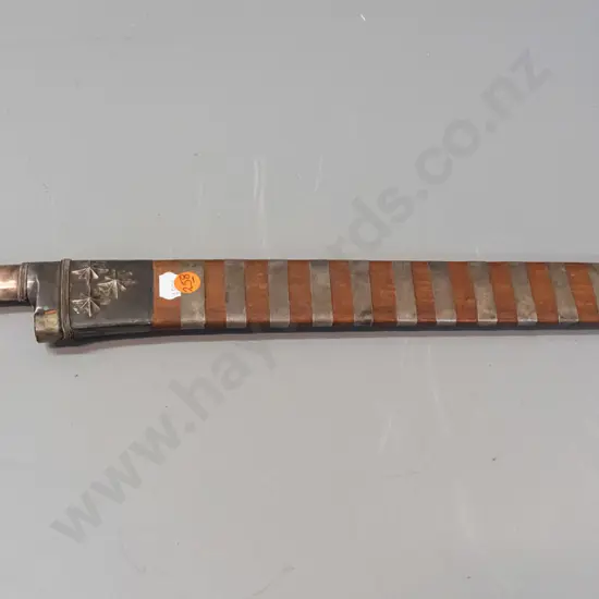 Sumatran single edged short blade sword with metal and ebony handle, wooden sheath with metal straps and banding. Some