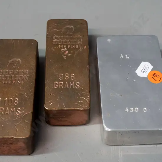3 metal ingots - 2 copper (1108g and 988g) and 1 aluminium 430g. Copper approx. 100 x 40 x 30