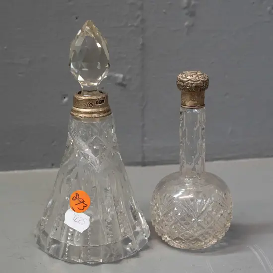 2 cut glass scent bottles, one with sterling silver cap and collar, one with sterling collar H-150