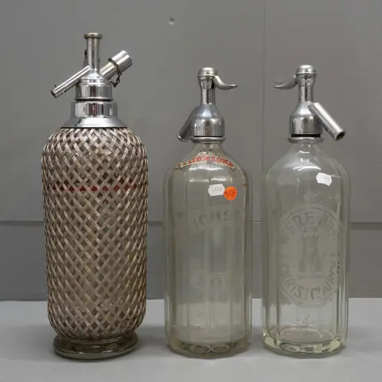 3 soda syphons - etched Were Bros Christchurch, etched Thomsons and an English with woven wire mesh covering H340. Some