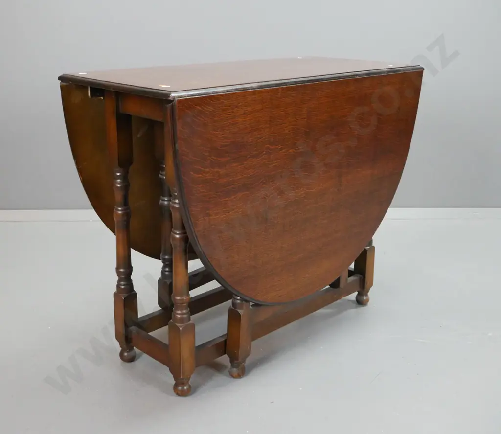 vintage oak oval gate-leg drop side table with turned legs and supports, square section stretcher base. Some stain marks Image 1++