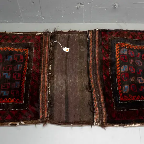 hand knotted wool Persian style saddle bag - geometric pattern dark red, blue, orange etc - most fringing is worn away,