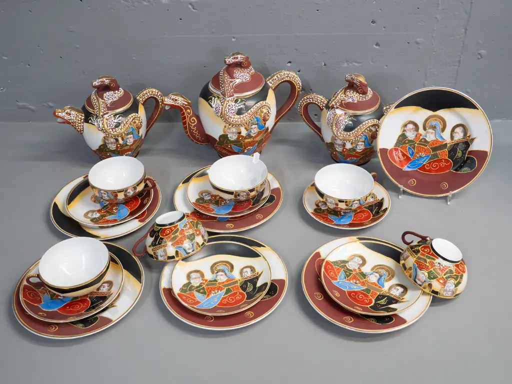 Japanese tea set with figural portrait and raised dragon motif decoration and lithophane geisha face in tea-cup base. Image 1++