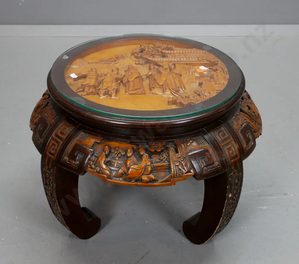 vintage Chinese round table with carved top and sides on 4 sweeping carved legs, glass top over carved scholar scene. Image 1++