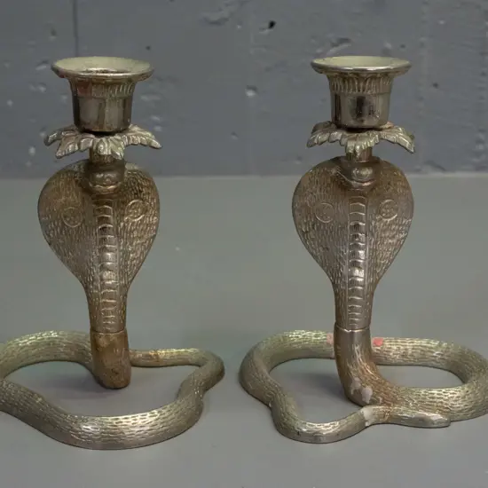 pair of cast metal cobra candlesticks H-170 W-120