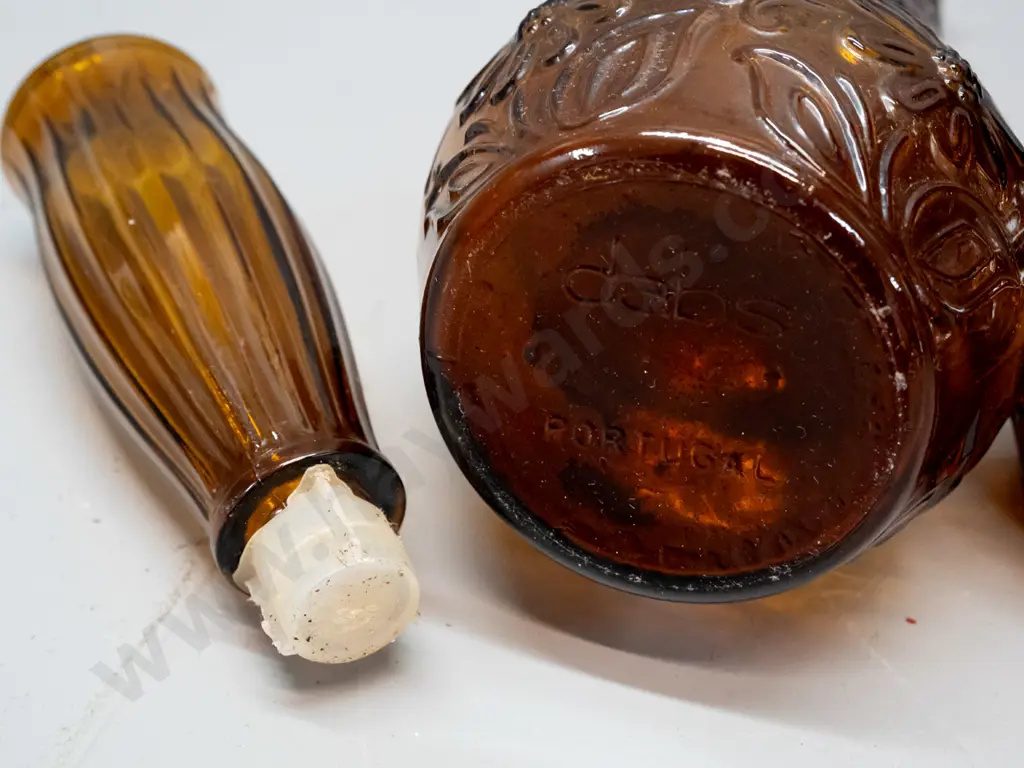 pair of retro moulded amber glass stoppered bottles - marked DABS Portugal on base. One has chip to rim, other has small Image 1++