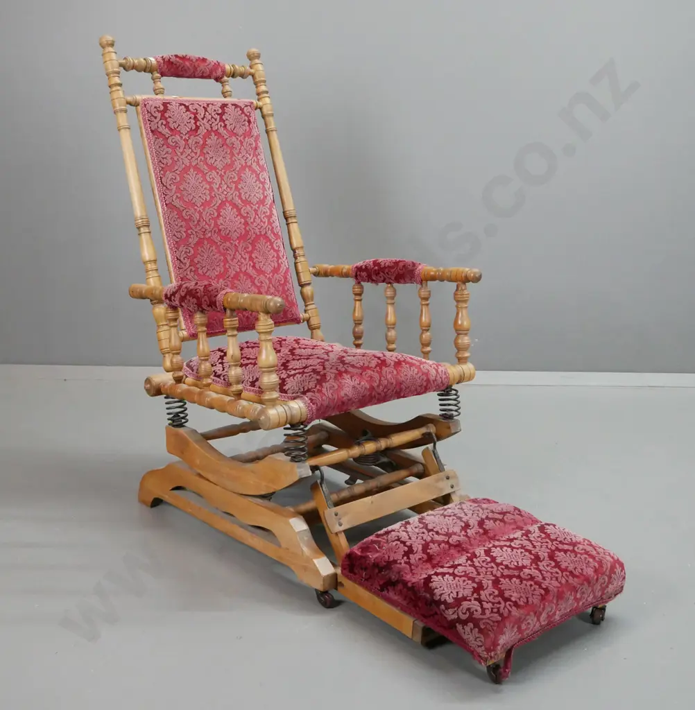 vintage mixed timber Dexter rocking chair slide-out foot rest, porcelain casters on foot rest. Some wear to red embossed Image 1++