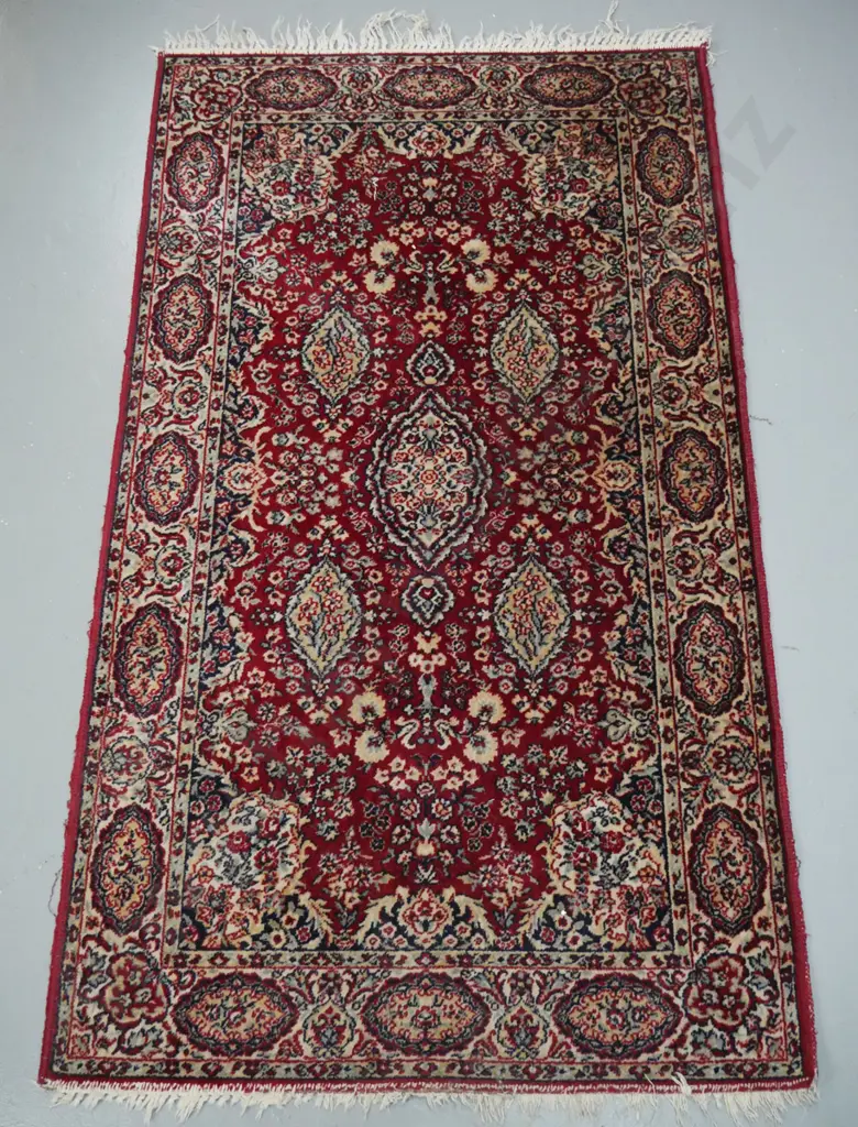 wool Persian style floor rug in red, ivory and blue. Wear to edges and fringe worn off one end L-1590 W-910 Image 1++