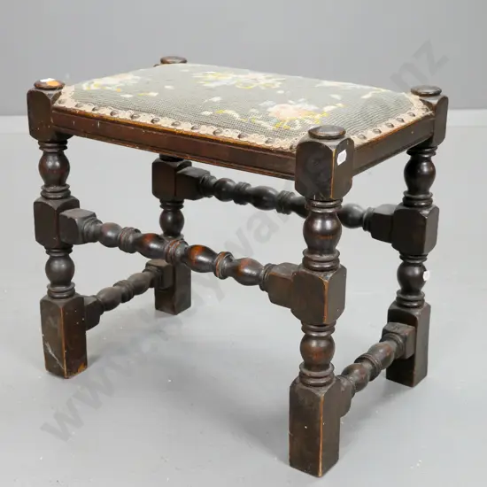 vintage oak tapestry top stool with turned stretchers, turned legs w/block feet. Some borer, some wear & stains to top.