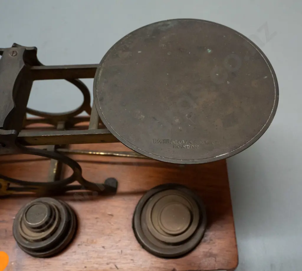 vintage brass balance scales on timber base with weights in fitted holes, one plate marked Waterlow & Sons London, plus Image 1++