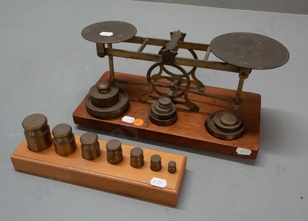 vintage brass balance scales on timber base with weights in fitted holes, one plate marked Waterlow & Sons London, plus Image 1++