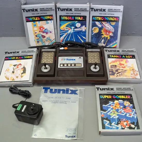 1980s Tunix Home Arcade video game console with 2 controllers, original manual, 6 game cartridges in original boxes -