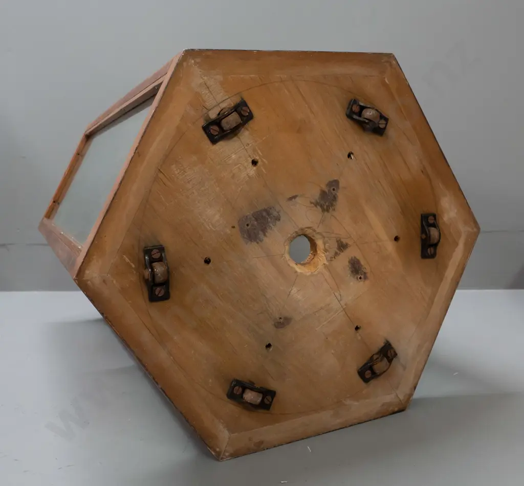 vintage hexagonal glazed timber display case on metal casters, one side has half panel and opening, 6 holes drilled in Image 1++