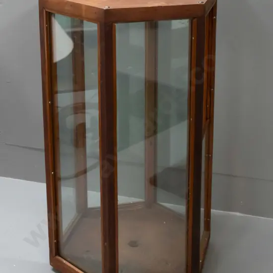 vintage hexagonal glazed timber display case on metal casters, one side has half panel and opening, 6 holes drilled in