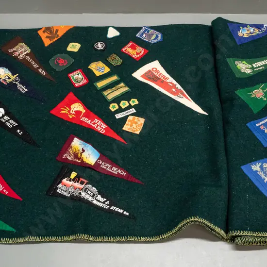 green woollen blanket with Onehunga label and numerous Boy Scouts and other badges, location pennants etc - some fading