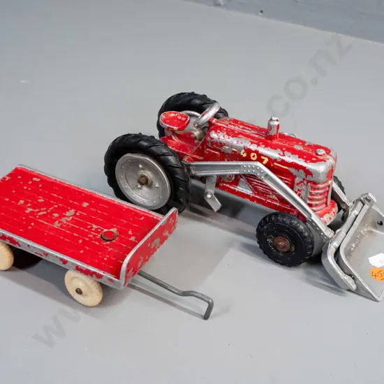 Fun Ho cast metal farm tractor and trailer.  Tractor marked No. 407, trailer No. 506. Paint wear, small defect to one