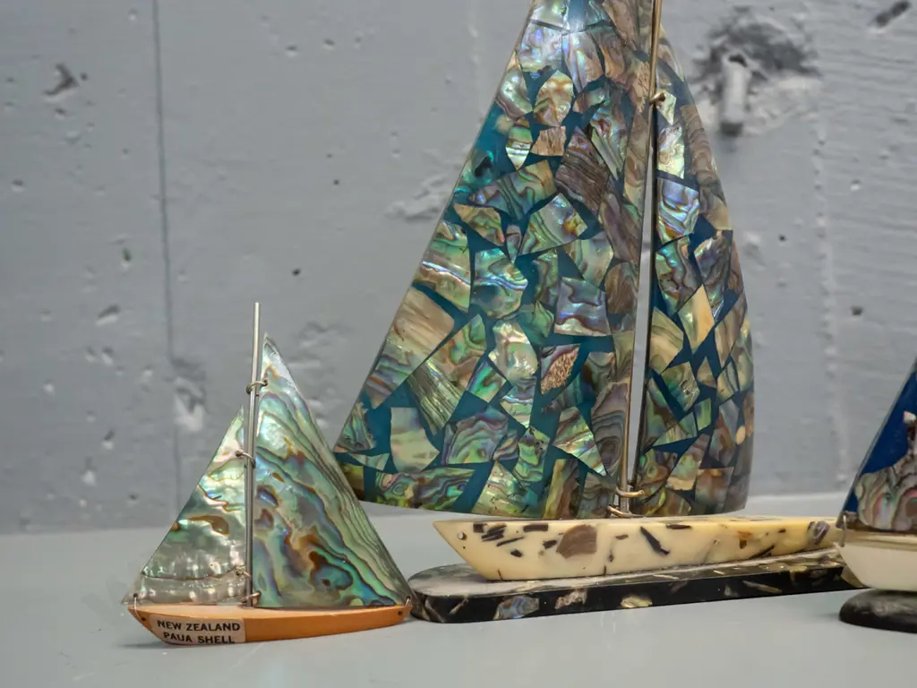 4 retro paua shell, acrylic & composite ornamental yachts, smallest has wooden base and a label. Large one has a slight Image 1++