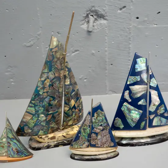 4 retro paua shell, acrylic & composite ornamental yachts, smallest has wooden base and a label. Large one has a slight