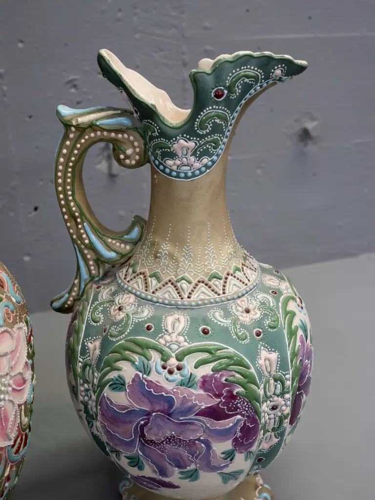2 Amphora style handled ewer jug vases with raised decoration and floral panels - larger is H-375 Image 1++