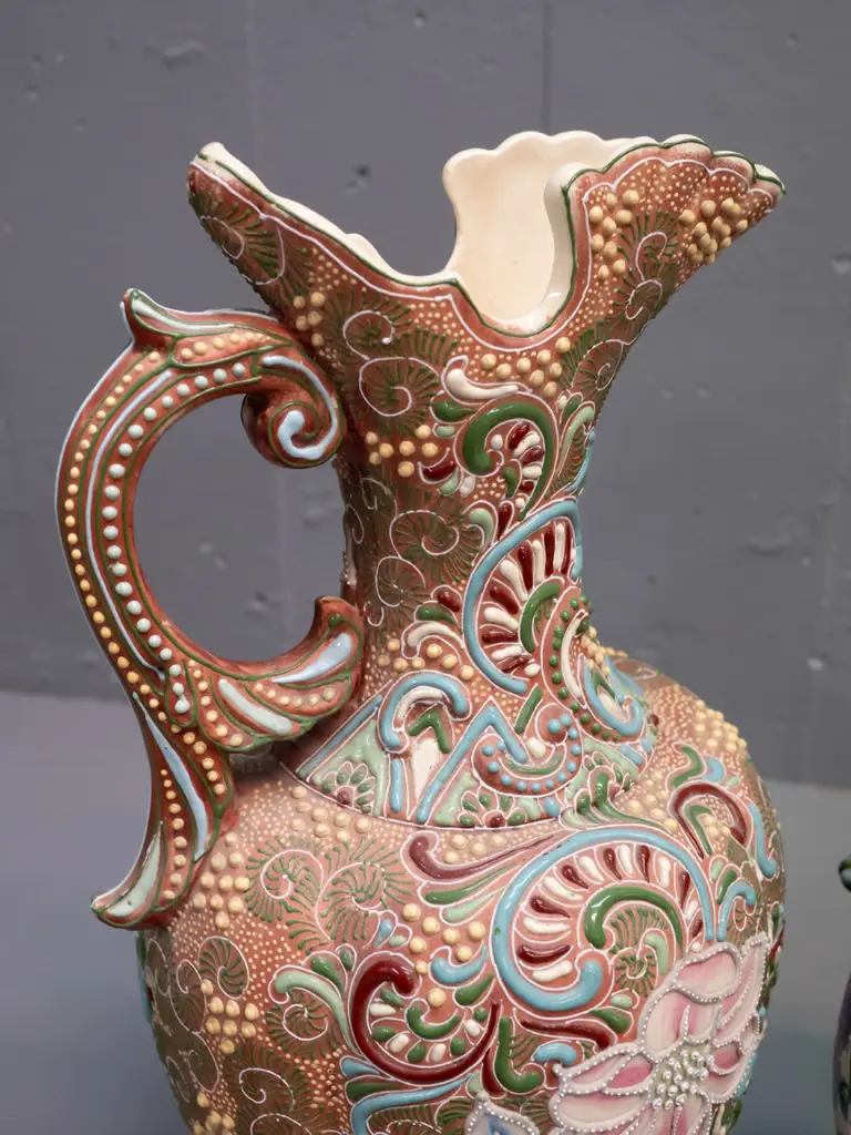 2 Amphora style handled ewer jug vases with raised decoration and floral panels - larger is H-375 Image 1++