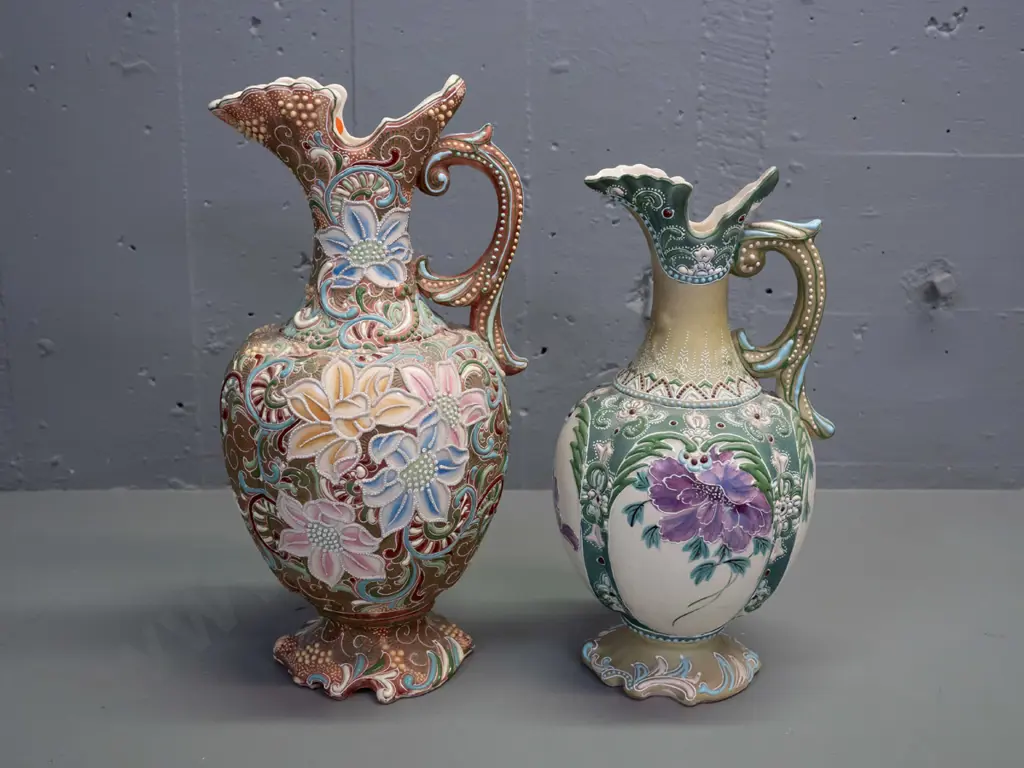 2 Amphora style handled ewer jug vases with raised decoration and floral panels - larger is H-375 Image 1++