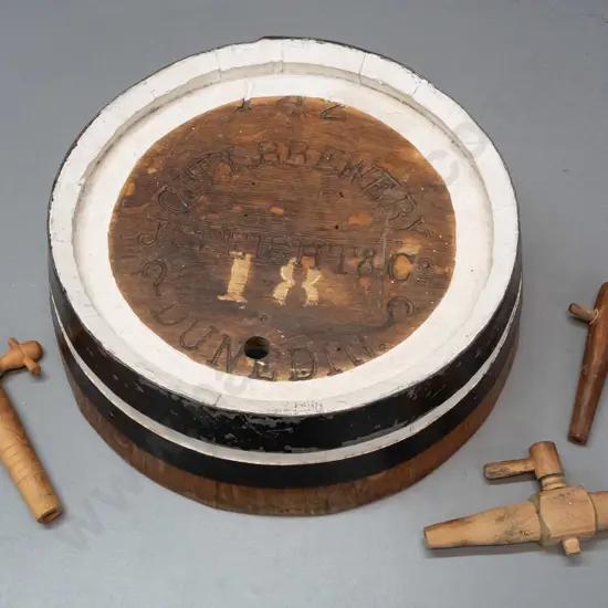 end piece from beer barrel with hanging rope - marked City Brewery / J. Speight & Co Dunedin - and 3 wooden spigots.