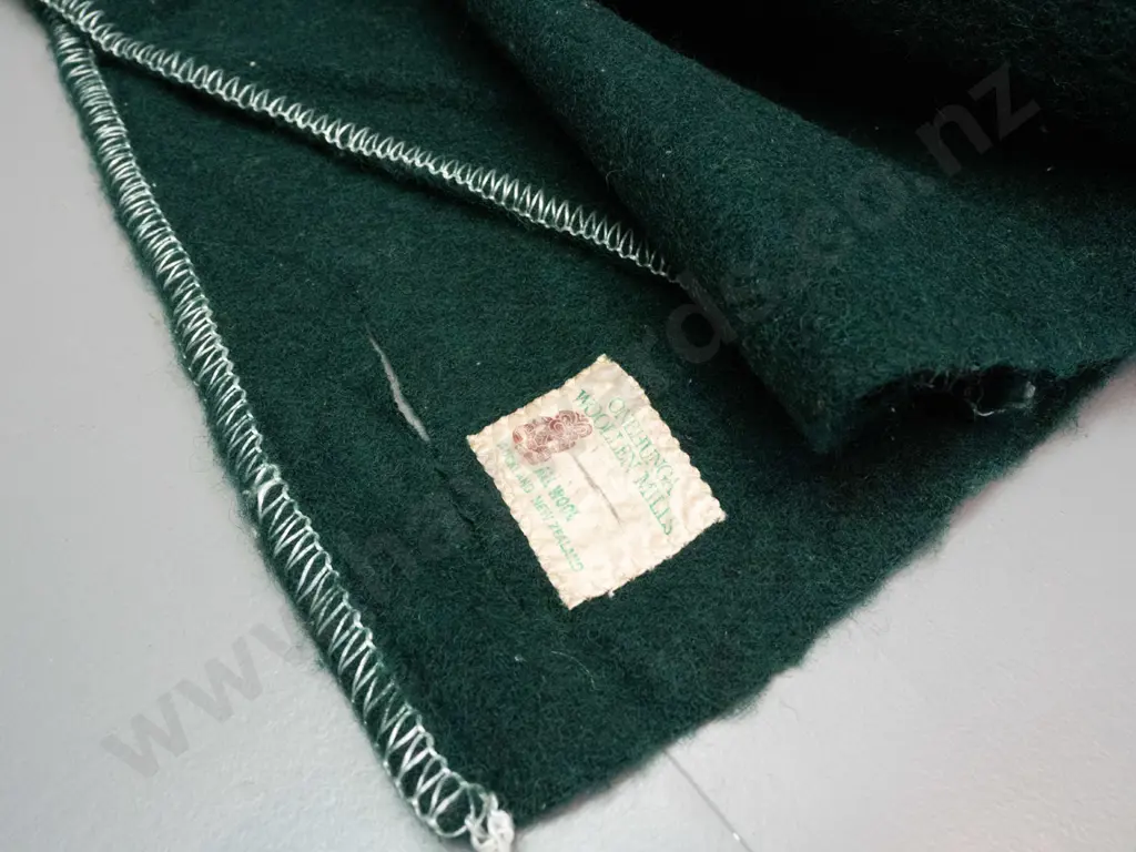 green woollen blanket with Onehunga label and numerous Girl Guides and other badges & NZ souvenir pennants - wear and a Image 1++